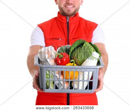 Delivery Man Holding Plastic Crate With Food Products On White Background, Closeup