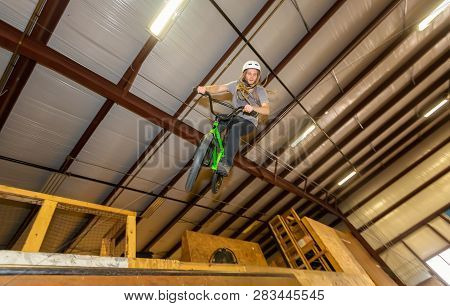 Man Jumping And Riding On A Bmx Bicycle At An Extreme Sports Park