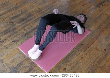 Sports Girl In Bodyflex Training. A Woman In A Black T-shirt Performs A Fitness Exercise On Stretchi