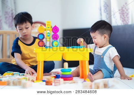 Brother And A Smile Boy Play A Toy Togather On The Bed, This Immage Can Use For Kid, Family, Educati