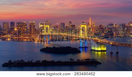 Tokyo Rainbow Bridge In Night Time With Tokyo City Background And Tower And Sunset Sky, This Immage 