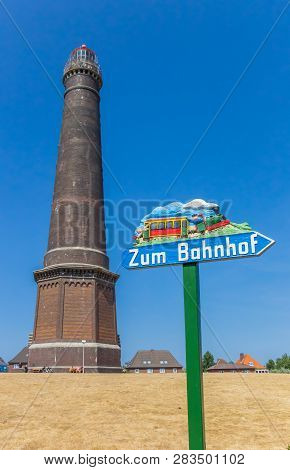Borkum, Germany - July 25, 2018: Information Sign And Lighthouse In The Center Of Borkum, Germany