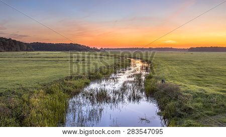 Sunset Landscape Of Lowland River Koningsdiep In The Netherlands