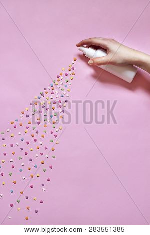 Abstract Pink Valentines Day Flat Lay. Top View Card. Womans Hand Is Spraying Little Hearts