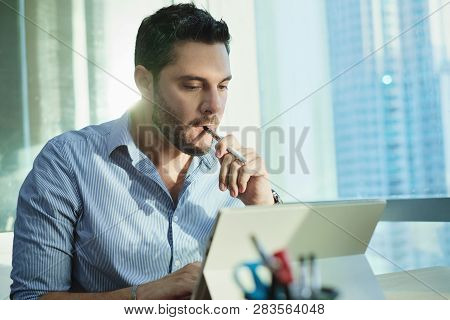 Ex-smoker Man Smoking Electronic Cigarette In Office While Working