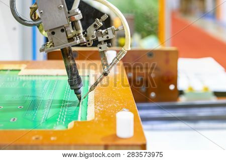 Close Up Iron Tip Of High Technology And Modern Automatic Robot For Pcb (print Circuit Board) Assemb