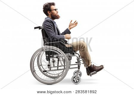 Full length profile shot of a young man in a wheechair gesturing with hand isolated on white background