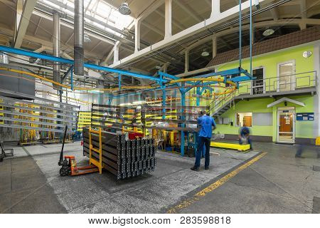 Powder Coating Line. Metal Panels Are Suspended On An Overhead Conveyor Line. Painting Products In A