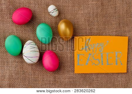 Congratulations With Easter On Burlap. Red And Green Easter Eggs On Burlap Sack. Decorative Styrofoa