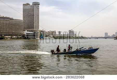 Cairo. Egypt.april 13, 2014.sailboats On The Nile In Cairo In Egypt Against The Backdrop Of Building