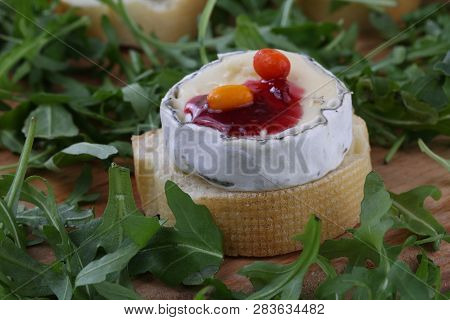 Cheese Saint-mor-de-touren With Raspberry Jam On White Wooden Background