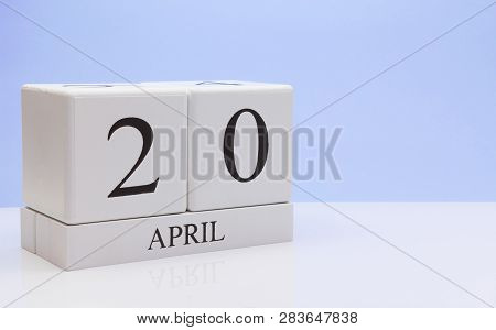 April 20st. Day 20 Of Month, Daily Calendar On White Table With Reflection, With Light Blue Backgrou