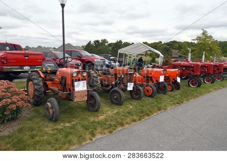 A Row Of Vintage Red Tractors Including Mccormick And Powerking On Display At The Bluffton Fall Fest