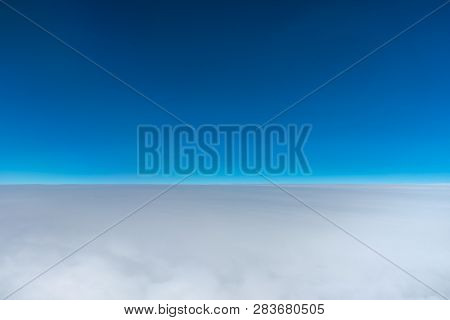 Dark Blue Sky Horizon, Up In The Air. Viewed From An Airplane Window.