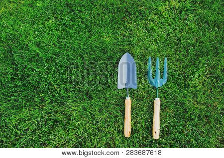 Garden Tools On Green Lawn Background. Seasonal Spring Or Summer Yard Work Concept, Growing And Seed