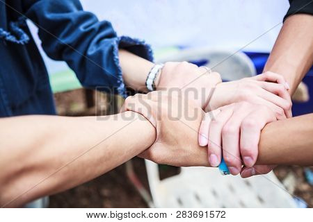 Young People Teamwork Meeting Join Hands In Rectangle On Natural Ground Background At Outdoor Outing