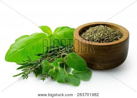 Dried Chopped Provence Herbs In A Dark Wood Bowl Next To Fresh Bouquet Garni Isolated On White.