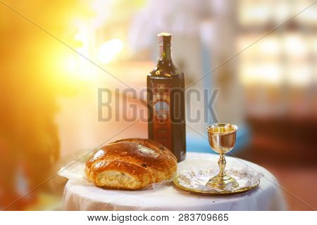 Holy Communion On Wooden Table In Church.taking Communion.cup Of Glass With Red Wine, Bread On Table