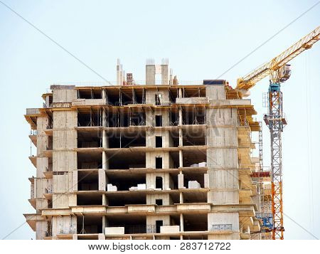 Construction Of A Multi-storey Residential Complex. Srlf-erecting Crane On A Construction Site. Cons