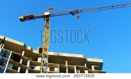 Crane. Construction Crane. Building Crane On The Background Of  A Building.