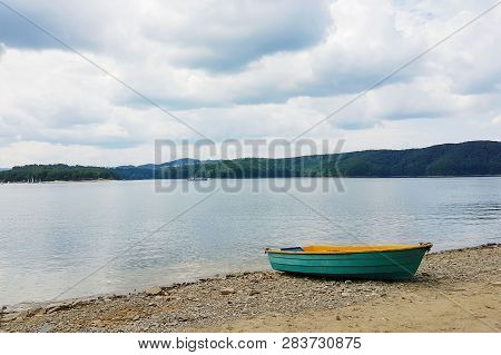 Mooring Boat Mooring On The Sandy Shore Of The Lake. Resort And Recreation Of People Near The Water.
