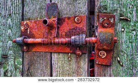 Old Rusty Metal Lock On Outdoor Gate In Village Time-worn House Nearby Minsk