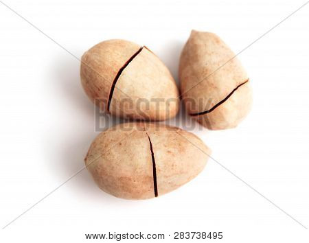 Three Unpeeled Pecan Nuts In Shell, With Cracks, Isolated On White Background.