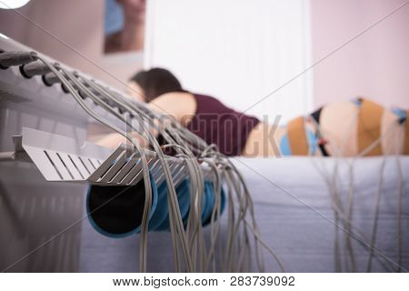 Young Woman With Dark Hair Taking Myostimulation At The Nutritionists Office, Close-up Of The Equipm