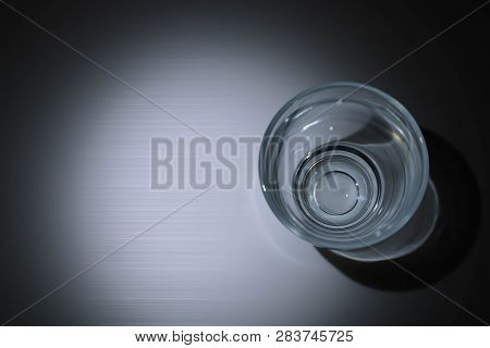 The Empty Glass With The Shadow Standing On The Table