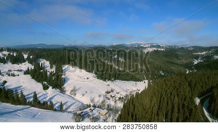 Aerial Helicopter View Of Of Cascade Mountain Range On Sunny Winter Day. Green Tree In A Winter Day