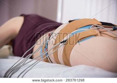 Close-up Of Young Woman With Dark Hair Taking Myostimulation At The Nutritionists Office, Close Up O