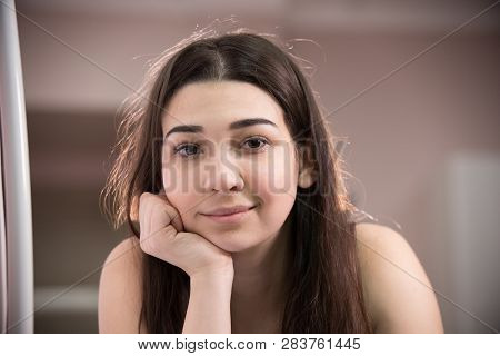 Portrait Of Young Woman With Brown Hair Taking Myostimulation Smiling And Looking Straight At The Ca