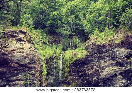 Little Waterfall In Green Summer Mountains, Norway.
