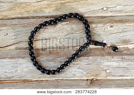 Prayer Beads On An Old Wooden Plate,image