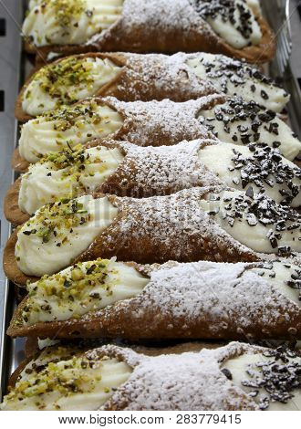 Many Typical Pastries Of The Sicily Region In Southern Italy Called Sicilian Cannoli In Italian Lang