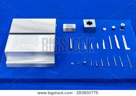 Many Type And Various Of Industrial Machining Parts On Blue Table Such As Nozzle Plug Ejector Pin Fo