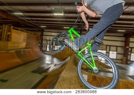 Man Jumping And Riding On A Bmx Bicycle At An Extreme Sports Park