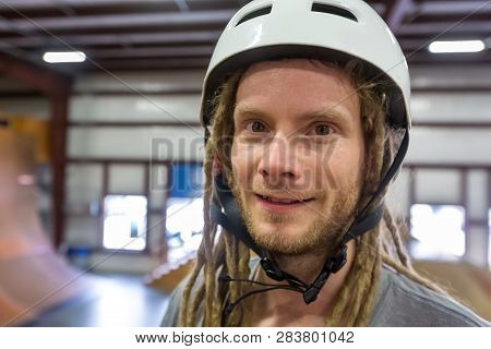 Portrait Of A Man With Dredlocks And A Helmet At An Extreme Sports Park