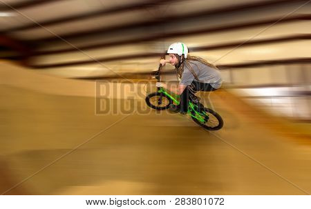Man Jumping And Riding On A Bmx Bicycle At An Extreme Sports Park