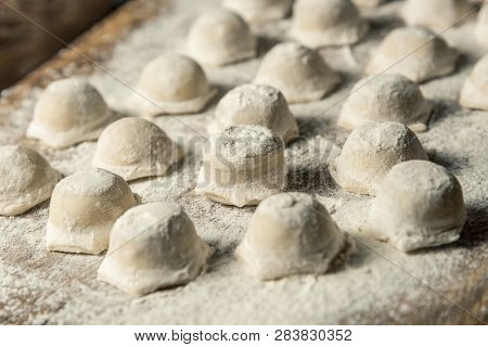 Uzbek National Food Chuchvara, Like Dumplings, On A Wooden Board, In Flour