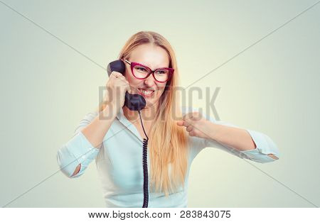 Young Screaming Woman In Glasses Speaking On Telephones Holding Fist In Air Nervous In Fear. Busines