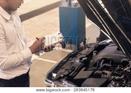 This Career Man Saleman Business Inspection Writing Note On Notepad Or Book, Paper With Car Blurry B