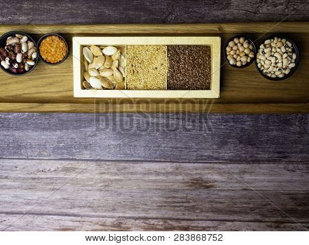 Different Kinds Of Bean Seeds, Lentil, Peas In Dish On Wooden Table, Macrobiotic Food Or Healthy Foo