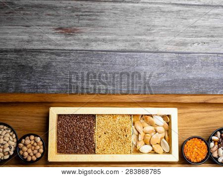 Different Kinds Of Bean Seeds, Lentil, Peas In Dish On Wooden Table, Macrobiotic Food Or Healthy Foo