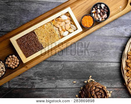 Cereal Grains: Red Lentils, Mung, Beans, Chickpea, Buckwheat On Wooden Kitchen Table With Flaxseeds,