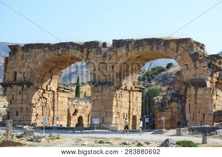 PAMUKKALE, TURKEY - AUGUST 18, 2011: People at Bath-Basilica in the ancient city of Hierapolis. Since 1988, Hierapolis is listed as UNESCO World Heritage site