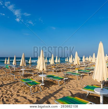 Morning Paradise White Sandy Beach With Sunshades And Sunbeds (salento, Puglia, South Italy). The Mo