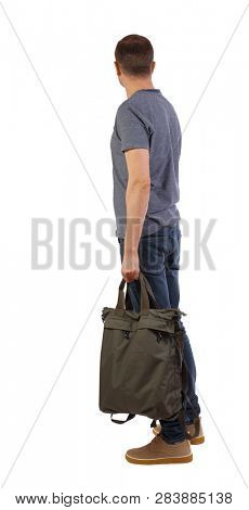 Back view of a man with a green bag.  backside view of person.  Rear view people collection. Isolated over white background. A student looks sideways holding a large bag.
