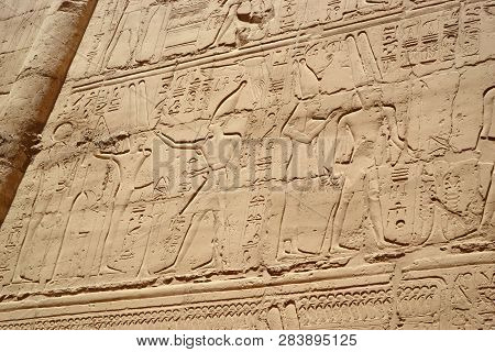 Egyptian Hieroglyphs, Symbols And Signs On A Stone Wall In Karnak Temple. Bass-relief.