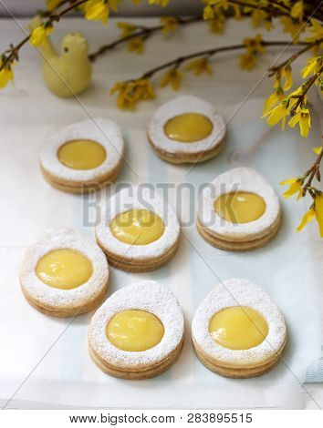 Homemade Easter Lemon Cookies And Forsythia Blooming Twigs On A Light Background.